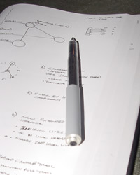 Sample 5: An uncapped pen on an open sketch book, showing diagrams and notes about a design